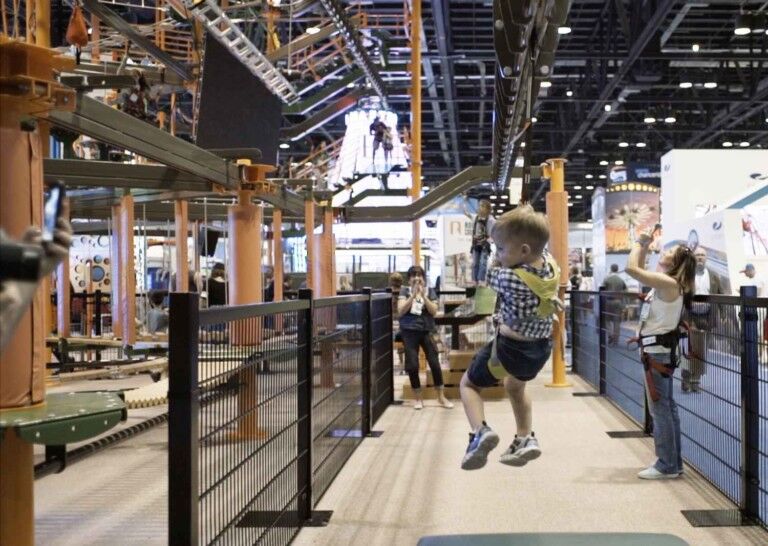 child tries Sky Tykes ropes course with sky rail zip line from innovative leisure