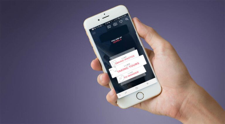 hand holding smartphone showing guru's new app for museum visitors
