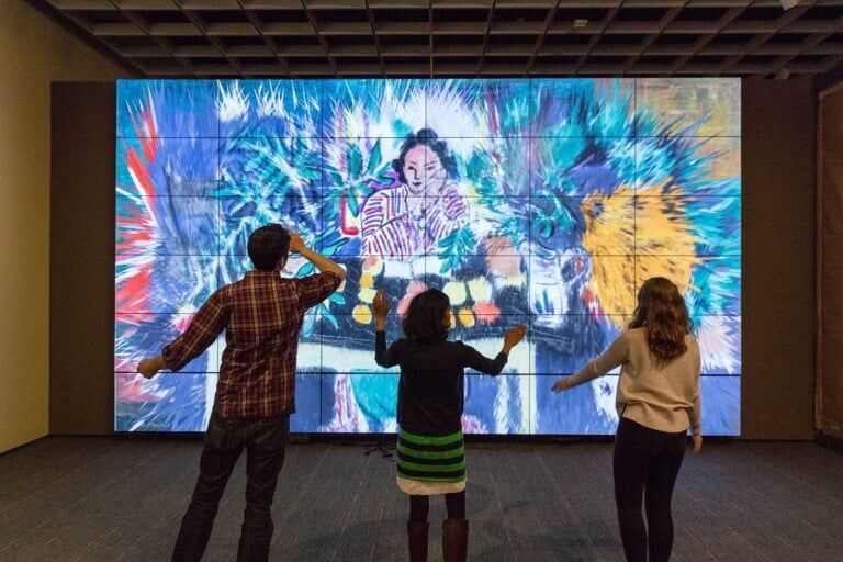 Three visitors interacting with the ArtLens Gallery at The Cleveland Museum of Art