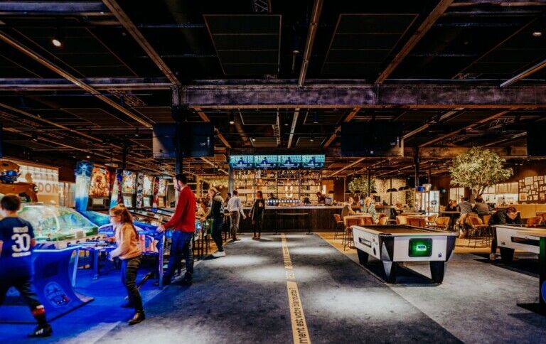 people playing in an arcade type building