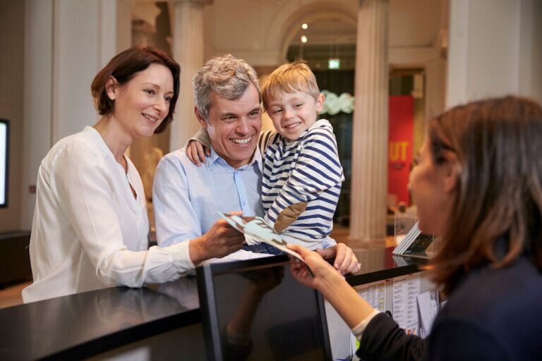 Family Buying Entry Tickets To Museum From Reception visitor research