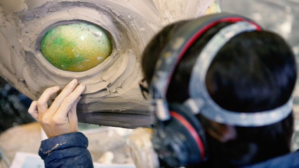 Wild Creations team member sculpting a creature