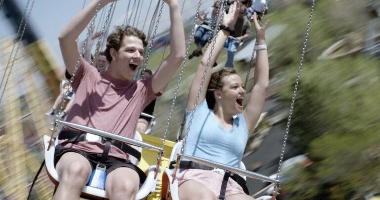 mand and woman on star flyer ride entertainment funtime attraction