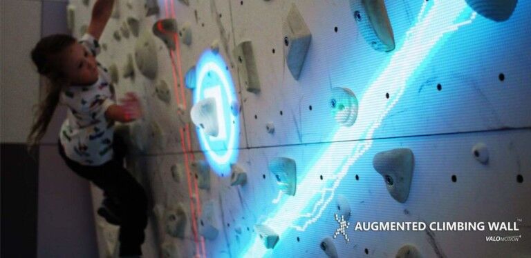 girl climbing valo motion augmented climbing wall
