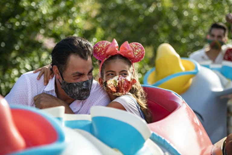 family-on-ride-at-Disneyland-in-masks storytelling after covid