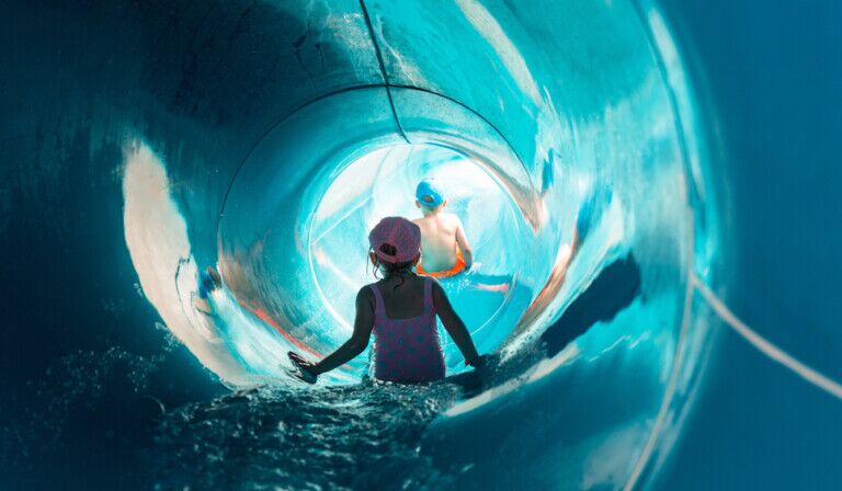 Two children on water slide at aquapark